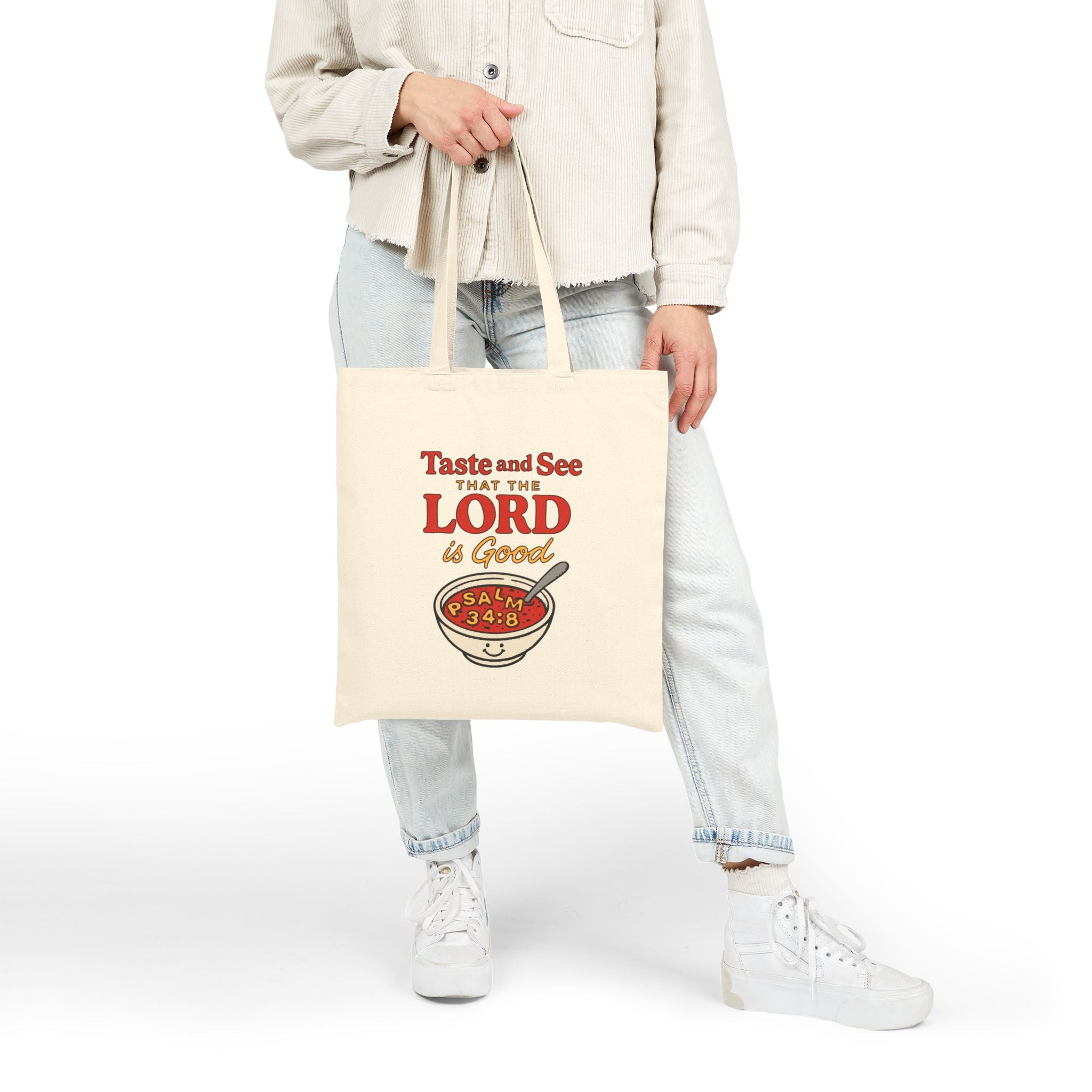 Person holding a tote bag with 'Taste and See the Lord is Good' text and a bowl graphic.